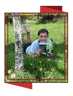 student reading under a tree