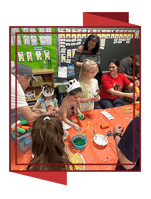adults helping students with crafts
