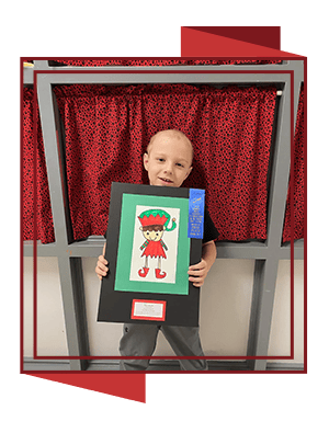 Student showing their artwork of an elf